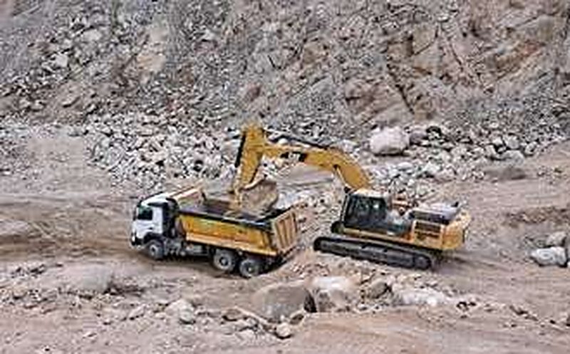 Excavator loading a dump truck